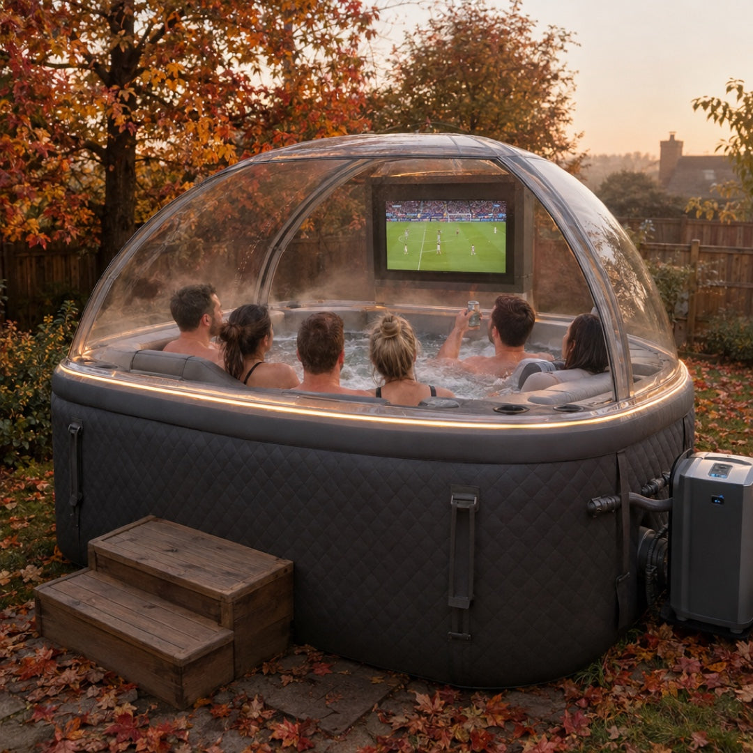 Rear view at golden hour — friends watching football on the TV inside the clear dome canopy