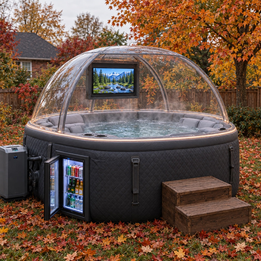Side view in daylight — clear dome canopy with the mounted TV, mini fridge door open with cold drinks, heater pump and wooden steps